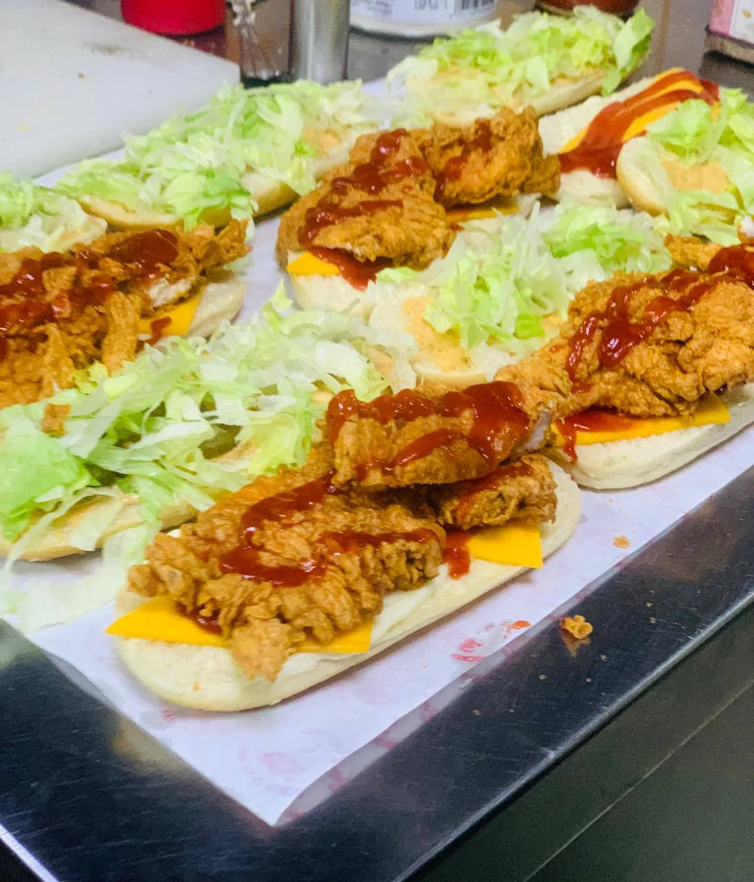 Fried chicken and cheese on flatbread with hot sauce
