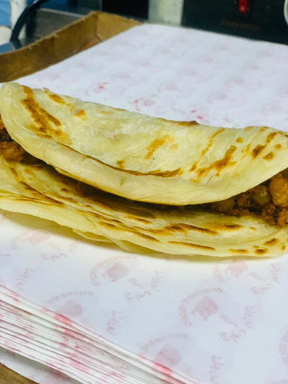Folded paratha fresh off the griddle