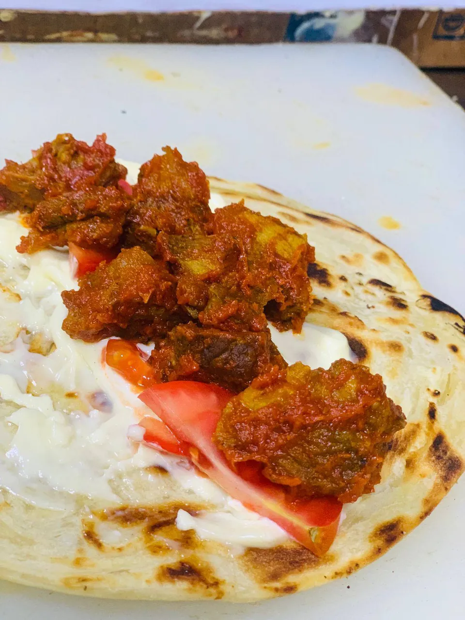 Chicken curry with tomato and mayonnaise on chapati