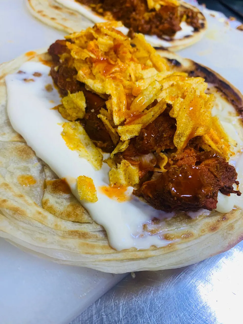 Chicken and crushed crisps rolled inside a paratha